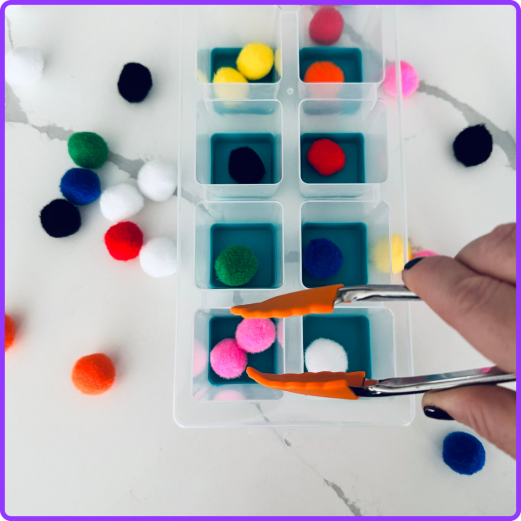 Placing a pink pom pom in the corresponding coloured spot in a task box activity